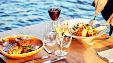 Gourmet meal onboard with wine and a view of the Seine