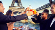 Group of friends toasting onboard with the Eiffel Tower in the background