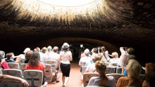 Passengers inside the Canal Saint-Martin tunnel under a light opening