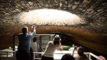 Tourists photographing the vaulted ceiling of the Canal Saint-Martin tunnel