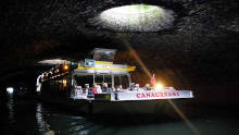 Canauxrama boat cruising through the Canal Saint-Martin tunnel