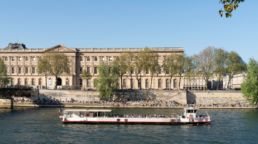 The Europa boat passing by the Louvre Museum during a Seine river cruise