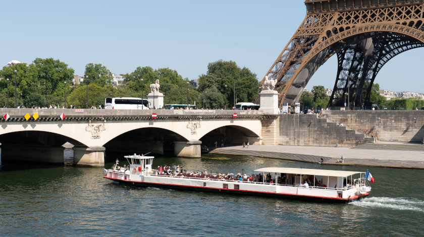 The Europa boat cruising on the Seine with a view of the Eiffel Tower