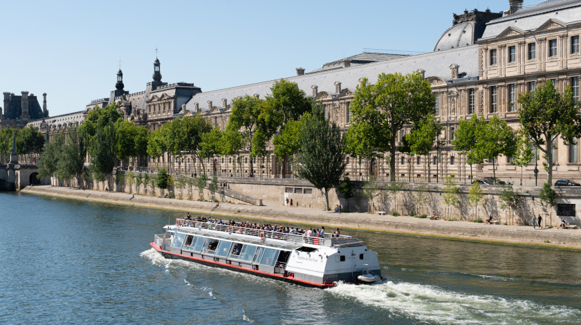 The Hydraseine boat passing by the Louvre Museum during a Seine river cruise