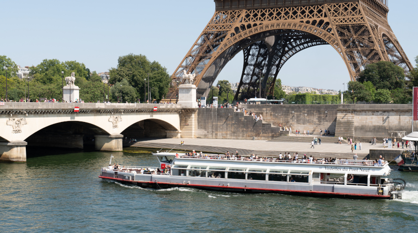 Vedettes du Pont Neuf passing by the Eiffel Tower during a Seine river cruise