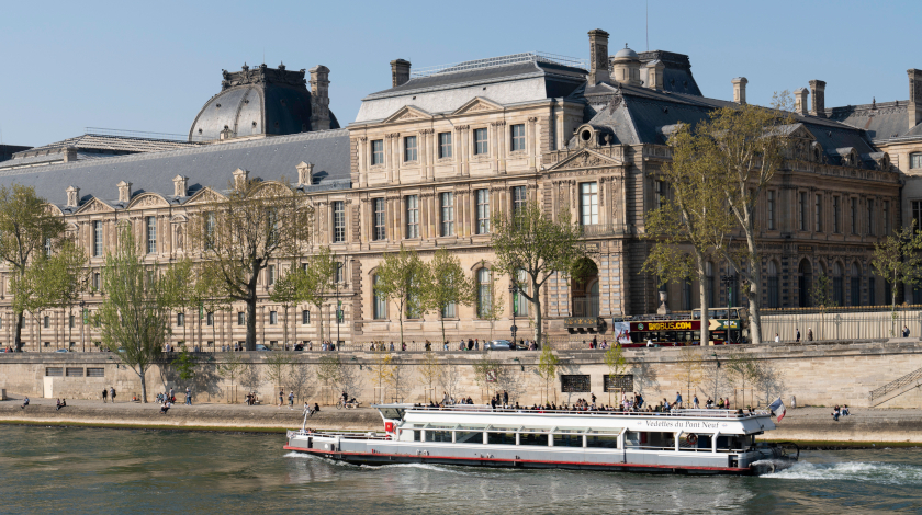View of the Louvre Museum from a Seine river cruise