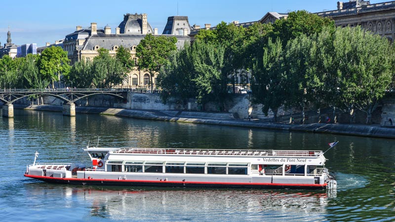 Sightseeing boat cruising on the Seine in the heart of Paris