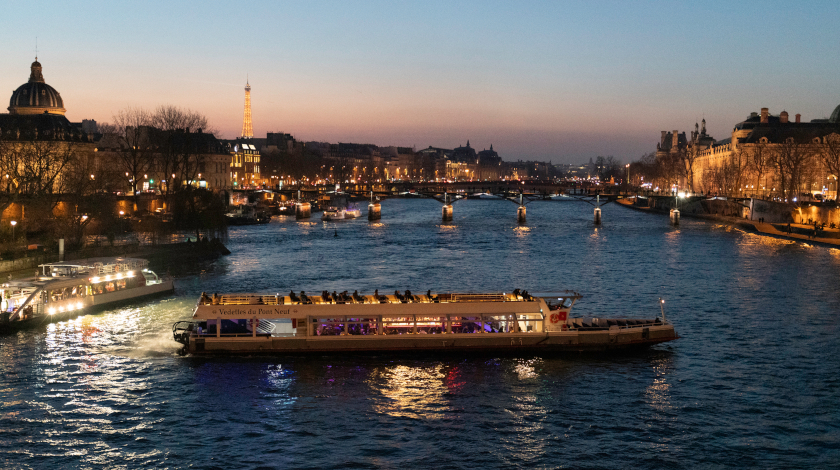 Night view of the Institut de France from a Seine river cruise